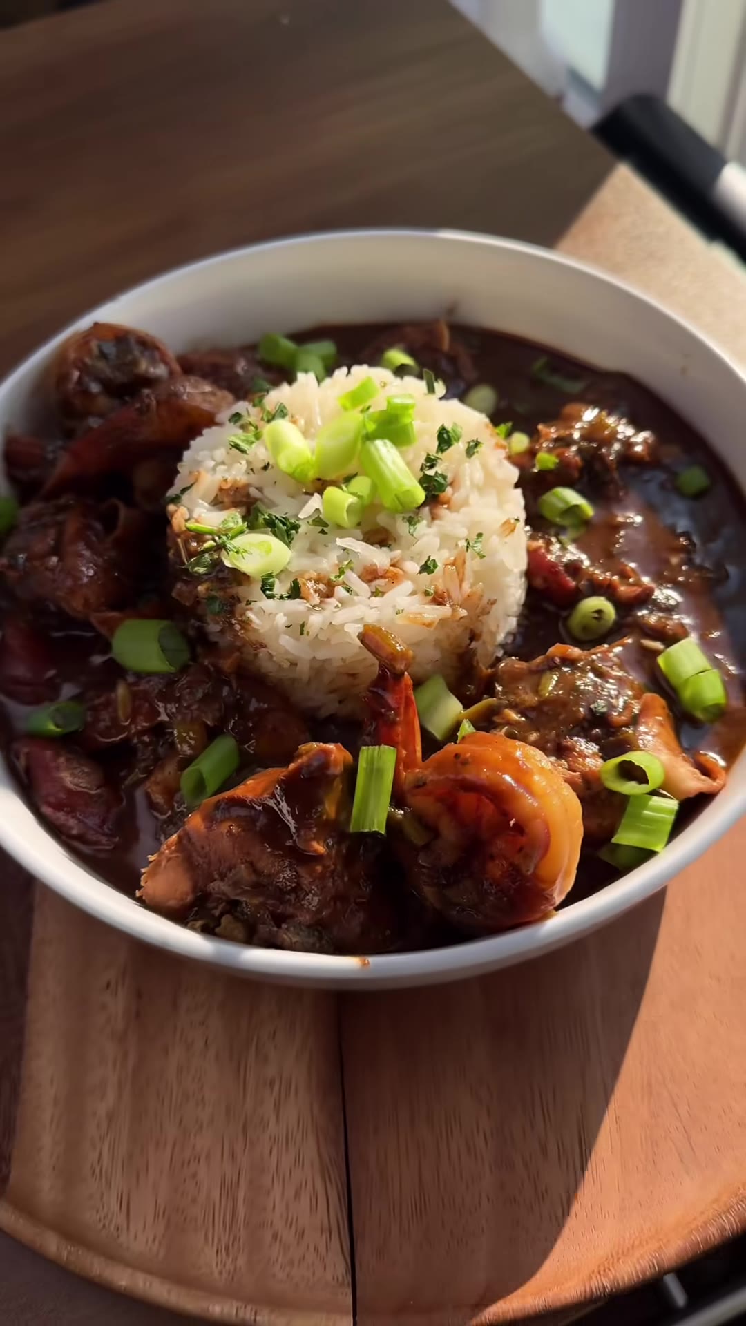 Seafood gumbo with rice, shrimp, and scallions